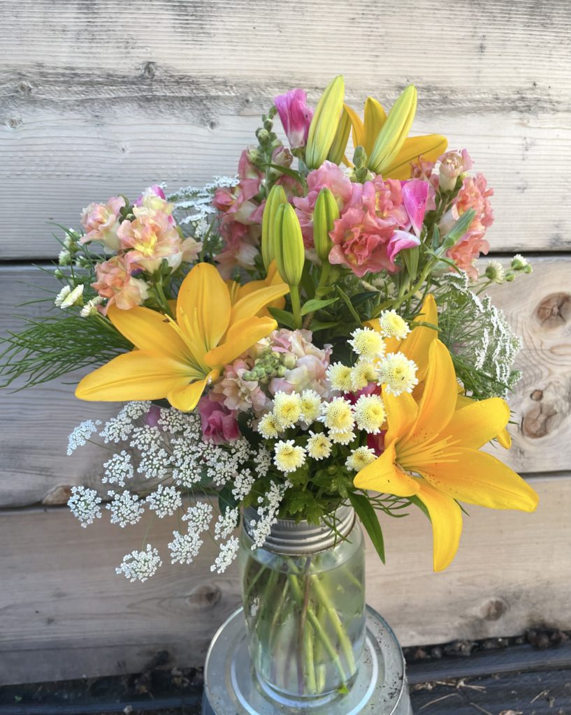 Yellow lily bouquet with white queen anne's lace and snapdragons