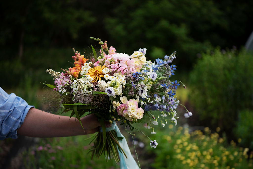 Bridal bouquet in white, pink and blue in a loose, romantic style.